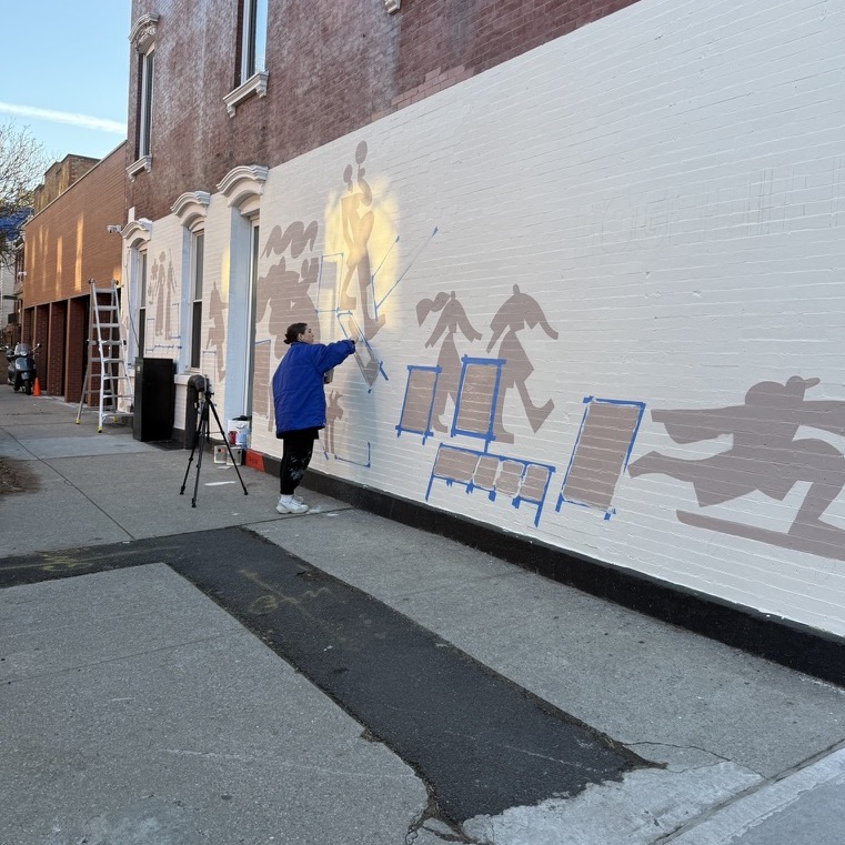 woman painting the side of the building by Gabriel
